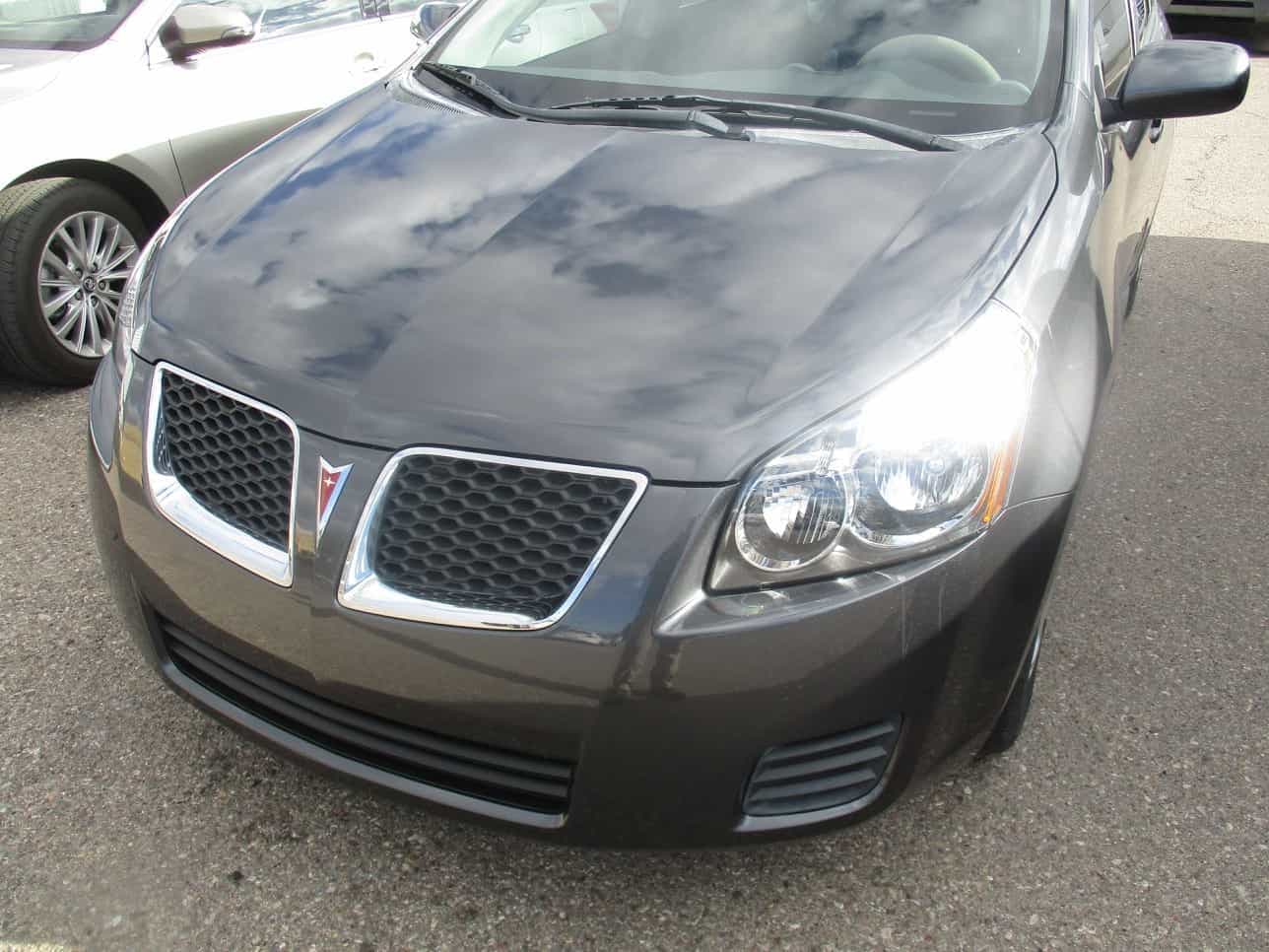 Same Pontiac Vibe — repaired front end, hood and grille restored, paint matched